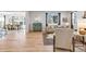 Open-concept living room with hardwood floors, neutral decor, and ample natural light at 821 Boulder Peak Ave, Erie, CO 80516