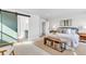 Spacious main bedroom showcases a decorative rug, wood bench, and sliding door to the ensuite at 821 Boulder Peak Ave, Erie, CO 80516
