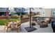 Outdoor patio with a dining table, comfortable seating, and a fire pit for relaxation at 821 Boulder Peak Ave, Erie, CO 80516