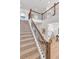 Inviting staircase with wrought iron balusters leads to the upstairs living spaces at 821 Boulder Peak Ave, Erie, CO 80516