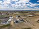 Stunning aerial view showcasing homes in the area, landscaping, adjacent fields, ponds and the city on the horizon at 9915 E 162Nd Pl, Brighton, CO 80602