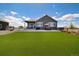 Expansive backyard featuring a well-maintained lawn and outdoor patio area at 9915 E 162Nd Pl, Brighton, CO 80602