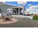 A peaceful backyard with a covered patio and fire pit area ideal for outdoor living at 9915 E 162Nd Pl, Brighton, CO 80602