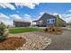 Backyard with manicured lawn, stone landscaping and patio with a hot tub at 9915 E 162Nd Pl, Brighton, CO 80602