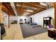 Unfinished basement with finished gym area featuring an open ceiling concept at 9915 E 162Nd Pl, Brighton, CO 80602