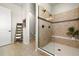 Modern bathroom with a frameless glass shower, double shower heads, and neutral tile at 9915 E 162Nd Pl, Brighton, CO 80602