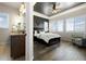 A luxurious bedroom with a modern ceiling fan, sleek gray accents, and stylish recessed ceiling at 9915 E 162Nd Pl, Brighton, CO 80602