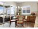 Bright breakfast nook featuring a sliding glass door to the outdoor area, a modern light fixture, and attractive hardwood floors at 9915 E 162Nd Pl, Brighton, CO 80602