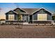 Beautiful single-story home with a stone accent, an inviting front porch, large windows, and manicured gravel landscaping at 9915 E 162Nd Pl, Brighton, CO 80602