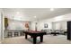 Spacious game room with a pool table, bar area, and comfortable seating at 9915 E 162Nd Pl, Brighton, CO 80602