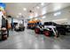 Large garage with lift, polished floors, and ample space for multiple vehicles at 9915 E 162Nd Pl, Brighton, CO 80602