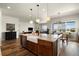Spacious kitchen island with granite counters, farmhouse sink, and stainless steel dishwasher at 9915 E 162Nd Pl, Brighton, CO 80602