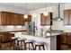 Modern kitchen with granite countertops, subway tile backsplash, and a large center island with seating at 9915 E 162Nd Pl, Brighton, CO 80602
