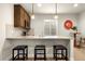 Modern wet bar featuring granite countertops, stylish lighting, and seating at 9915 E 162Nd Pl, Brighton, CO 80602
