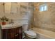 Updated bathroom with tiled shower and floors, vanity, and modern fixtures at 132 Delaware St, Denver, CO 80223
