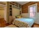 Bedroom featuring a built-in wardrobe with exposed brick and hardwood floors at 132 Delaware St, Denver, CO 80223
