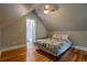 Attic bedroom features a ceiling fan, hardwood floors, and a light-filled ambiance at 132 Delaware St, Denver, CO 80223