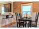 Dining area with exposed brick wall, modern lighting, and access to the breakfast bar at 132 Delaware St, Denver, CO 80223