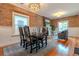 Open dining area with exposed brick wall, modern lighting, and seamless living room access at 132 Delaware St, Denver, CO 80223