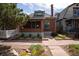 Charming brick home featuring a well-manicured lawn and inviting walkway at 132 Delaware St, Denver, CO 80223