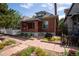Charming brick home featuring a well-manicured lawn and inviting walkway at 132 Delaware St, Denver, CO 80223