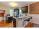 Modern kitchen with stainless steel appliances, granite countertops, and a breakfast bar at 132 Delaware St, Denver, CO 80223