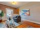 Bright living room with hardwood floors, exposed brick wall, and large window at 132 Delaware St, Denver, CO 80223