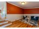 Cozy living room with hardwood floors, brick accent wall, and wainscoting at 132 Delaware St, Denver, CO 80223