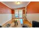 Bright living room with exposed brick, French doors, and hardwood floors at 132 Delaware St, Denver, CO 80223