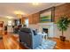 Cozy living room with hardwood floors, brick accent wall, and a decorative fireplace at 132 Delaware St, Denver, CO 80223