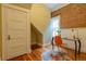 Home office with hardwood floors, exposed brick wall, and natural light at 132 Delaware St, Denver, CO 80223