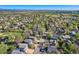 An aerial view showcases a neighborhood with tree-lined streets and diverse rooftops at 10963 Bryant St, Westminster, CO 80234