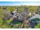 Aerial view of the backyard with a well-kept lawn, playset, wooden deck, and mature trees for shade and privacy at 10963 Bryant St, Westminster, CO 80234