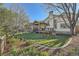 View of the lush backyard with a covered deck, playset, and flower garden for outdoor enjoyment at 10963 Bryant St, Westminster, CO 80234