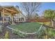 Backyard features a covered patio, mature landscaping, and a beautiful lawn at 10963 Bryant St, Westminster, CO 80234