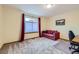 Bedroom featuring a large window, a red sofa, and neutral carpeting at 10963 Bryant St, Westminster, CO 80234