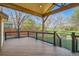 Spacious covered deck featuring a wooden ceiling, black railings, and views of the backyard, ideal for outdoor gatherings and relaxation at 10963 Bryant St, Westminster, CO 80234