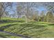 Scenic view of a well-manicured lawn, lush greenery, and mature trees, complemented by a flowing stream, enhancing the tranquil setting at 10963 Bryant St, Westminster, CO 80234