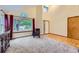 Bright living space with large window and high ceilings, adjacent to a dining area at 10963 Bryant St, Westminster, CO 80234