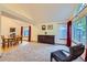 Comfortable sitting room with large windows, leading to a dining area and kitchen at 10963 Bryant St, Westminster, CO 80234