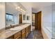 Bathroom boasts double sinks, tile flooring, a soaking tub, and an enclosed glass shower at 10963 Bryant St, Westminster, CO 80234