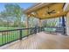 Covered deck featuring a ceiling fan, railings, wood floors, and seating with a view of the backyard at 10963 Bryant St, Westminster, CO 80234