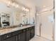 Contemporary bathroom featuring double vanity, granite countertops and walk-in shower at 11902 Norfolk Ct, Commerce City, CO 80022