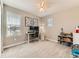 Well-lit bedroom with a desk, a ceiling fan and carpeted floors at 11902 Norfolk Ct, Commerce City, CO 80022