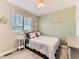 Charming bedroom with a single bed, ceiling fan, and stylish decor at 11902 Norfolk Ct, Commerce City, CO 80022