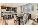 An open-concept dining area featuring modern decor, neutral tones, and seamless kitchen access at 11902 Norfolk Ct, Commerce City, CO 80022