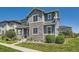 Two-story home with stone facade, porch and manicured front lawn at 11902 Norfolk Ct, Commerce City, CO 80022