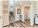Inviting foyer with wood-look flooring, staircase, and neutral décor at 11902 Norfolk Ct, Commerce City, CO 80022