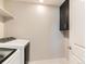 Bright laundry area with white cabinets and modern white washer and dryer at 11902 Norfolk Ct, Commerce City, CO 80022