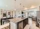 Open concept living space with kitchen island and granite countertops and stainless steel appliances at 11902 Norfolk Ct, Commerce City, CO 80022